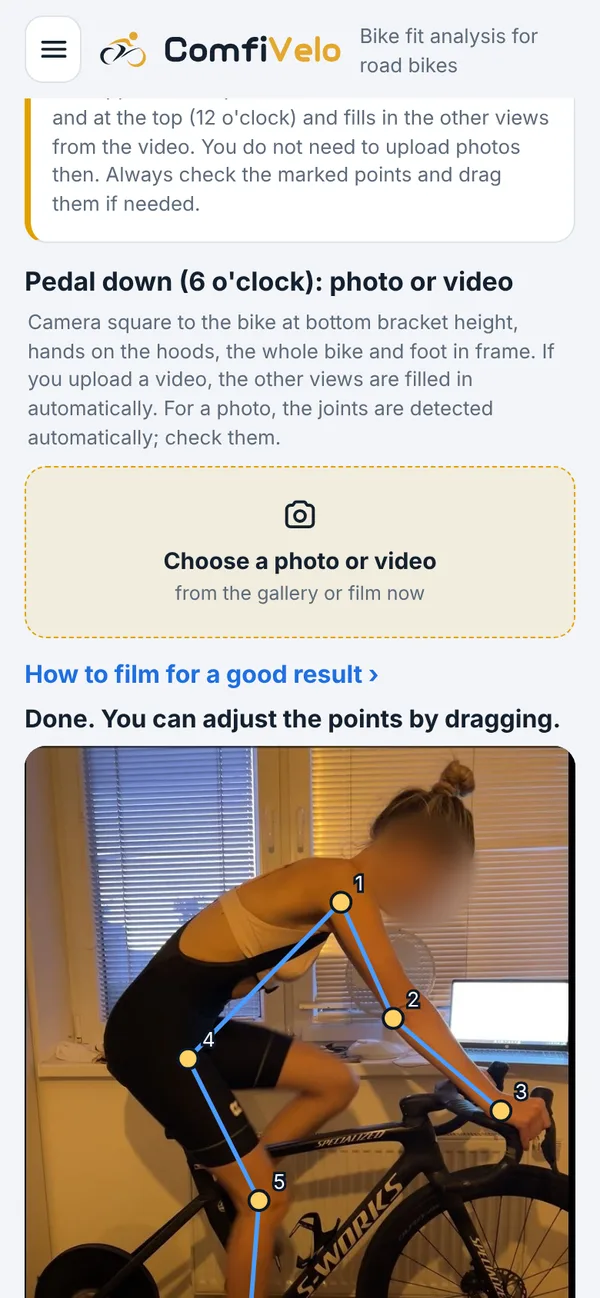 Screen with points on a rider's photo, face blurred